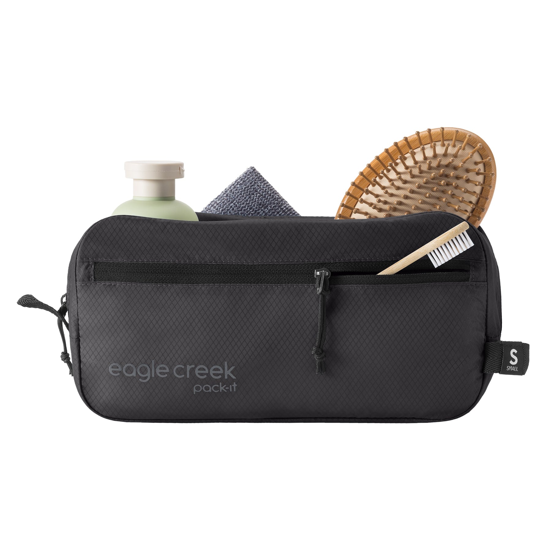 Black toiletry bag with travel items on a white background
