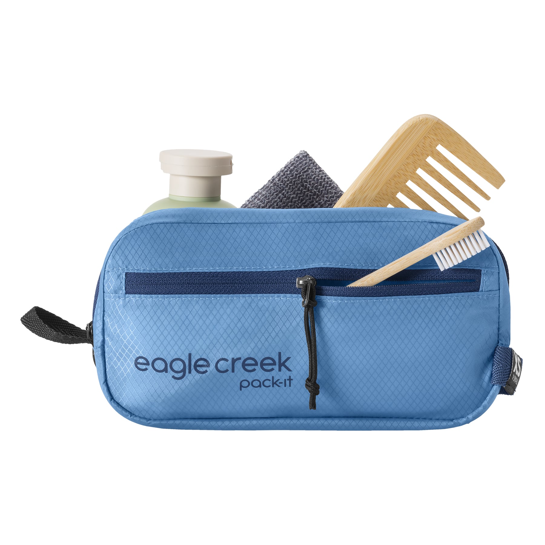 Blue toiletry bag with travel items on a white background, featuring the Eagle Creek brand.